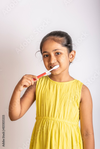 Happy little girl brushing teeth. Dental hygiene. Oral health or hygiene.