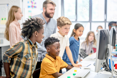 Diverse children learning computer skills in classroom.