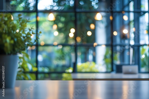 Blurred office interior background with a blurred desk and window light bokeh, a working space in the style of a modern business center for presentation or meeting.