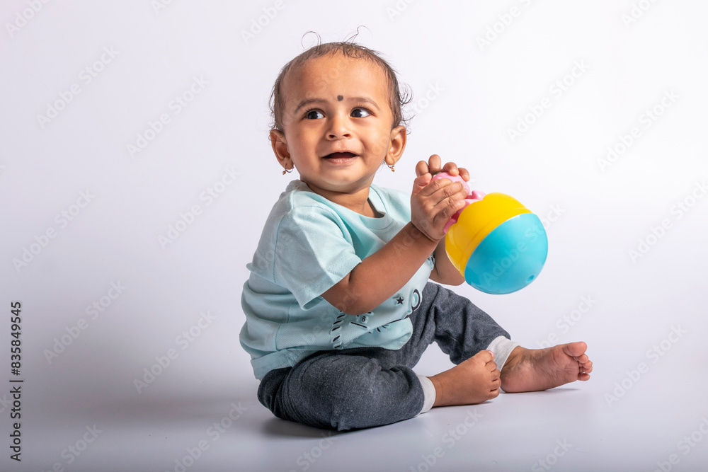 Joyful baby playing with toys. baby boy fun play with rolly polly toy. Little baby kid playing with balancing doll. Joyful baby playing with toys. baby boy fun play with rolly polly toy. Little baby kid playing with balancing doll.