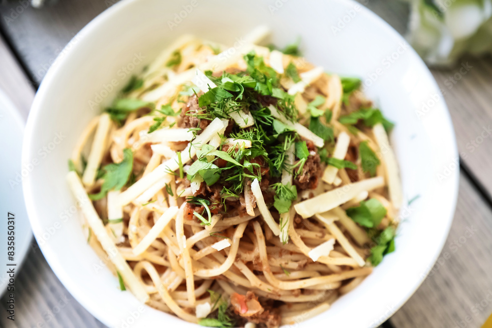 White Bowl Filled With Food on Wooden Table