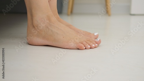 Картината върху платно Morning unfolds as female feet gracefully descend from bed, embracing dawn