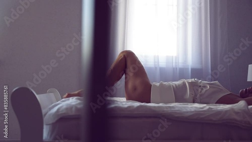 Beautiful slim legs and perfect woman body lying on the white bed