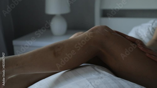 Woman preparing to use hydrating cream for her legs
