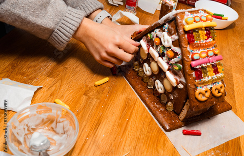 A young woman painted with sugar gingerbread cookies house