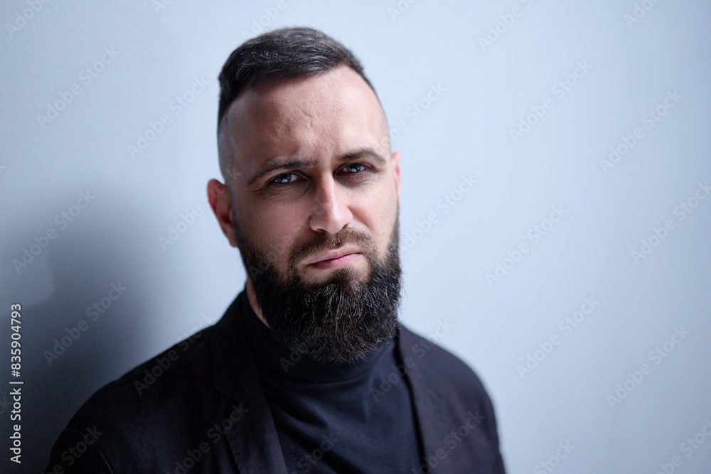 Studio portrait of young handsome man with beard. Studio portrait of young handsome man with beard.