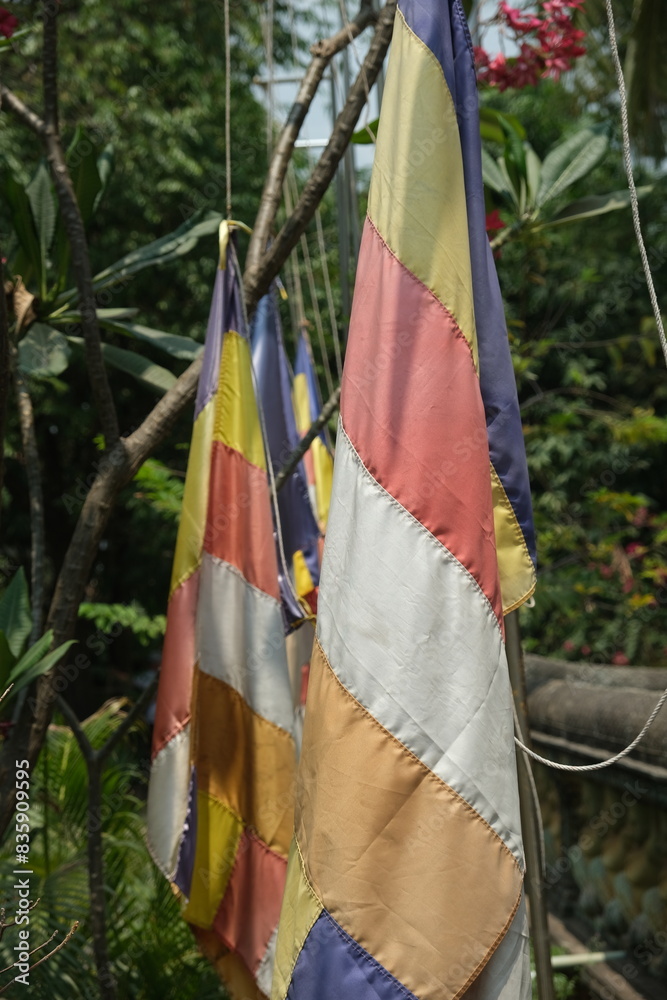 colorful flags in the courtyard of a Cambodian temple colorful flags in the courtyard of a Cambodian temple
