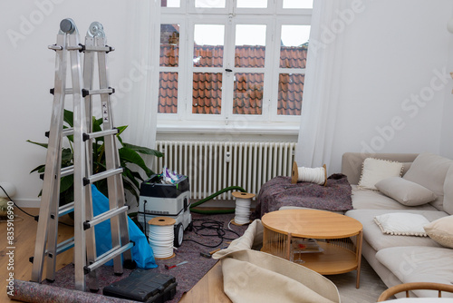Ladder and vacuum cleaner with cover mats. Renovation in a house, moving