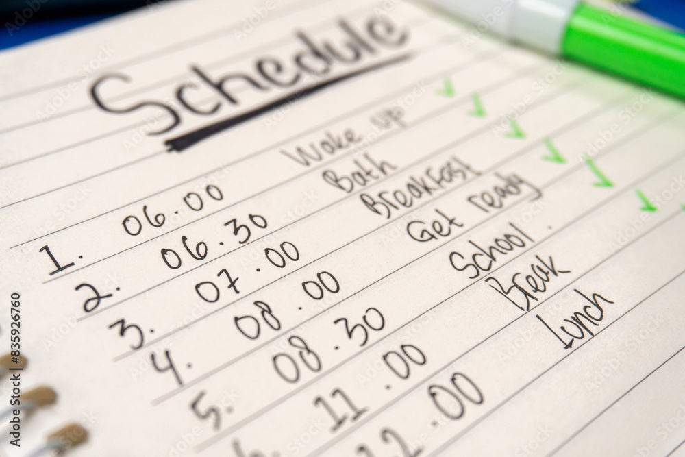 close up of daily activity schedule in a notebook with marker close up of daily activity schedule in a notebook with marker