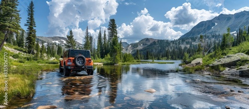 Jeep Rubicon is riding thru rough and rugged terrain to the lake photo