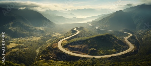Aerial view of a curved winding road trough the mountains. Creative banner. Copyspace image photo