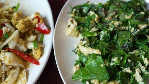 Close up and Top View of Stir Fried Crab with Curry Powder and Stir Fried Malindjo Leaves with Egg. Southern Local Food of Thailand Concept photo