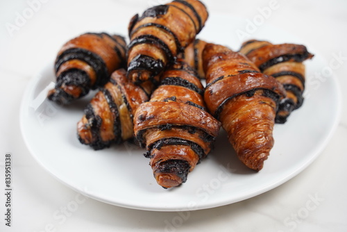 Delicious fresh baked Rugelach with chocolate filling on plate photo