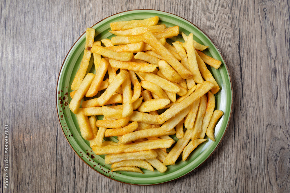 French fries served on plate on table French fries served on plate on table