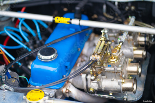 Shiny and well maintained engine inside the car. Bright blue car engine color. Auto fuel mixer photo