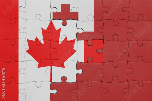 puzzle with the colourful national flag of Tonga and flag of canada.