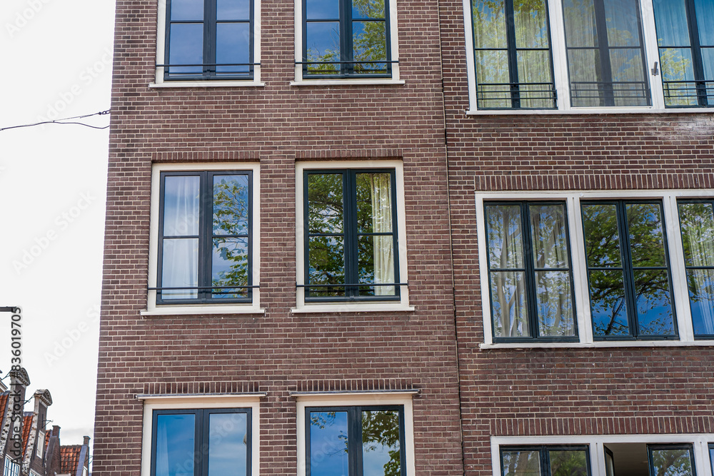 Fototapeta premium Amsterdam downtown old houses. Nice view of the famous city of Amsterdam. Travel to Europe. Amsterdam, Holland, Netherlands, Europe.