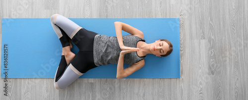 Young woman practicing yoga...