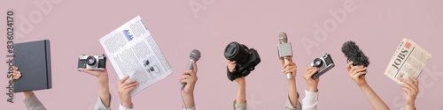 Bild auf Leinwand Female hands with newspaper, notebook, microphone and photo camera on color back