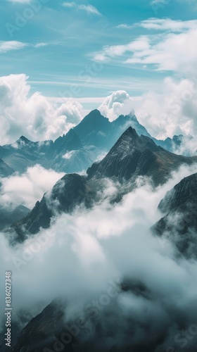 Mountains surrounded by thick clouds, creating a dramatic and atmospheric scene © AlfaSmart
