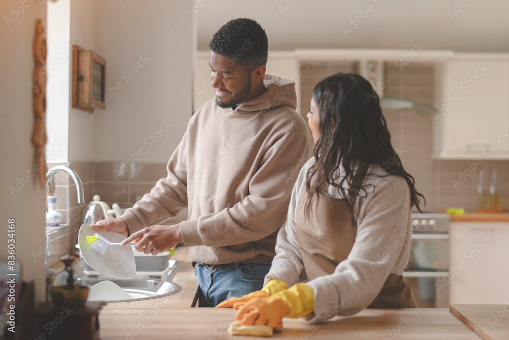 man helping woman cleaning kitchen washing dishes together at home toned image man helping woman cleaning kitchen washing dishes together at home toned image