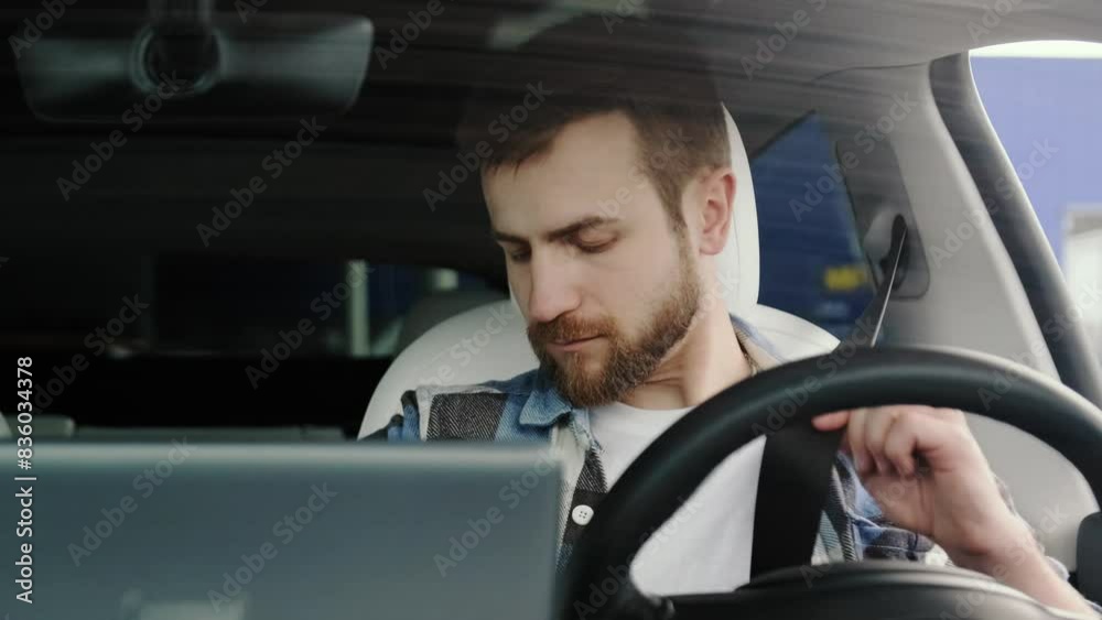 Young man using seat belt, looking at back view mirror in the car. Slow motion Young man using seat belt, looking at back view mirror in the car. Slow motion