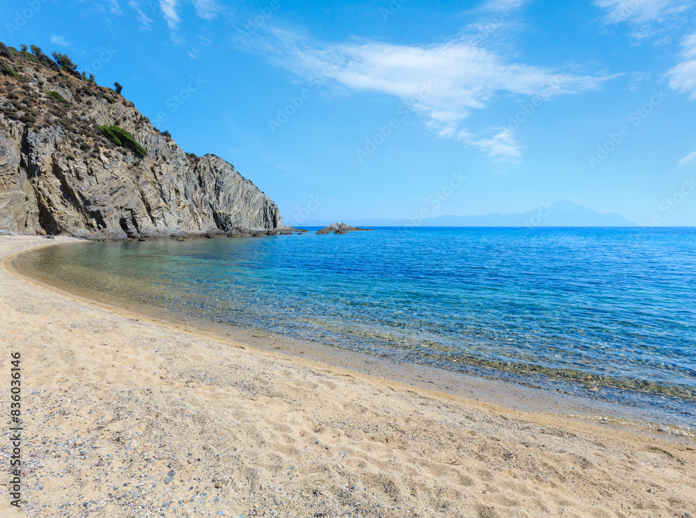 Summer sea scenery with aquamarine transparent water and sandy beach. View from shore (Goa Beach Bar, Sithonia, Halkidiki, Greece). Summer sea scenery with aquamarine transparent water and sandy beach. View from shore (Goa Beach Bar, Sithonia, Halkidiki, Greece).