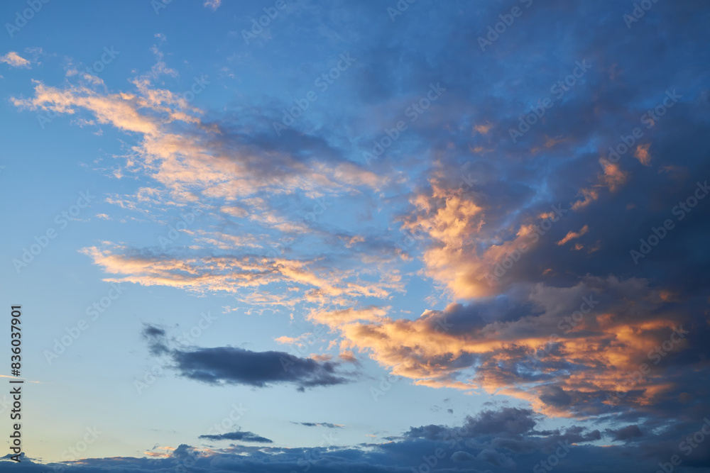 Obraz premium A fragment of a bright sunset sky with bizarrely shaped clouds