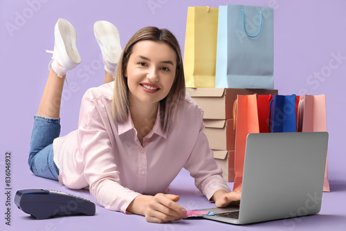 Young woman with laptop sho...