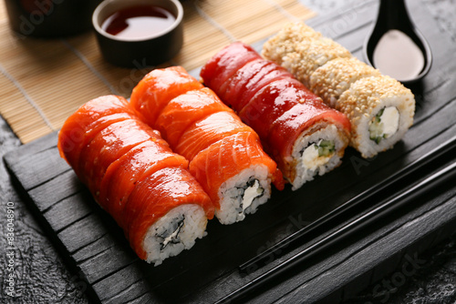 Assorted sushi rolls with s...
