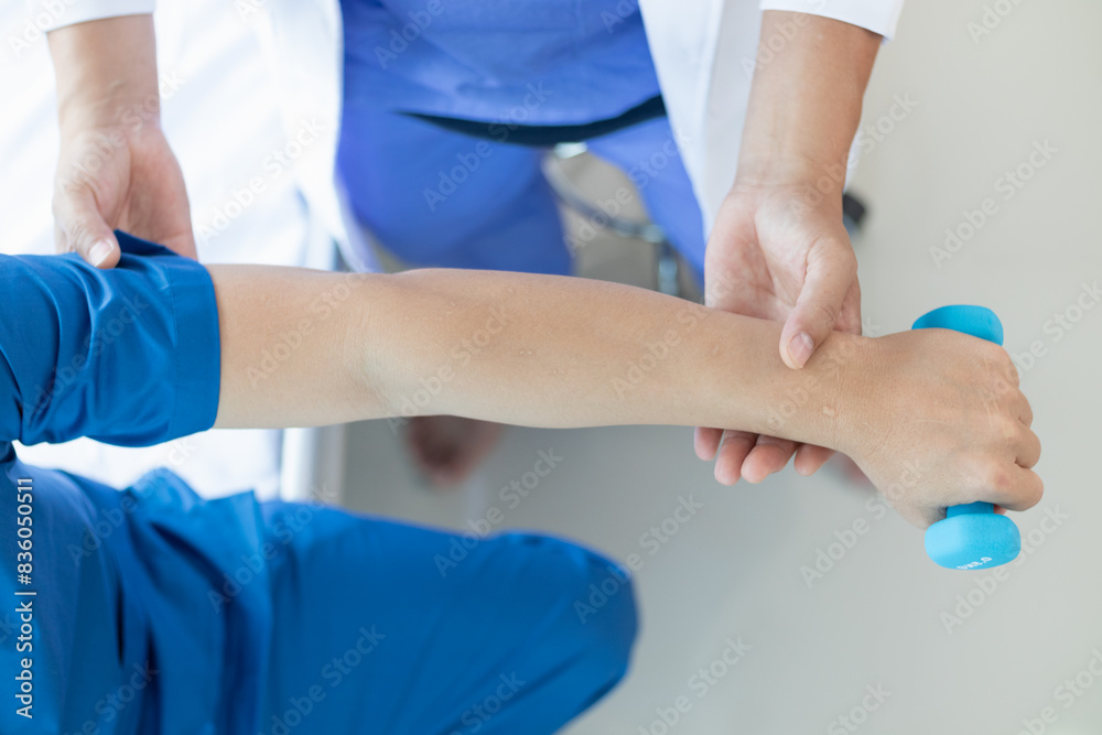 doctor is helping a patient move her muscles after recuperating from a muscle injury and wanting to rehabilitate her to be able to use her normal daily life with continuous physical therapy. doctor is helping a patient move her muscles after recuperating from a muscle injury and wanting to rehabilitate her to be able to use her normal daily life with continuous physical therapy.
