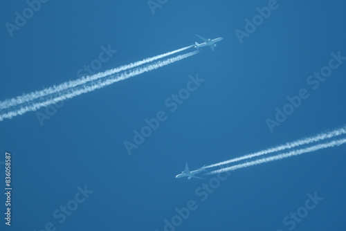 two planes in the sky, two airplane tracks in the blue sky, contrails