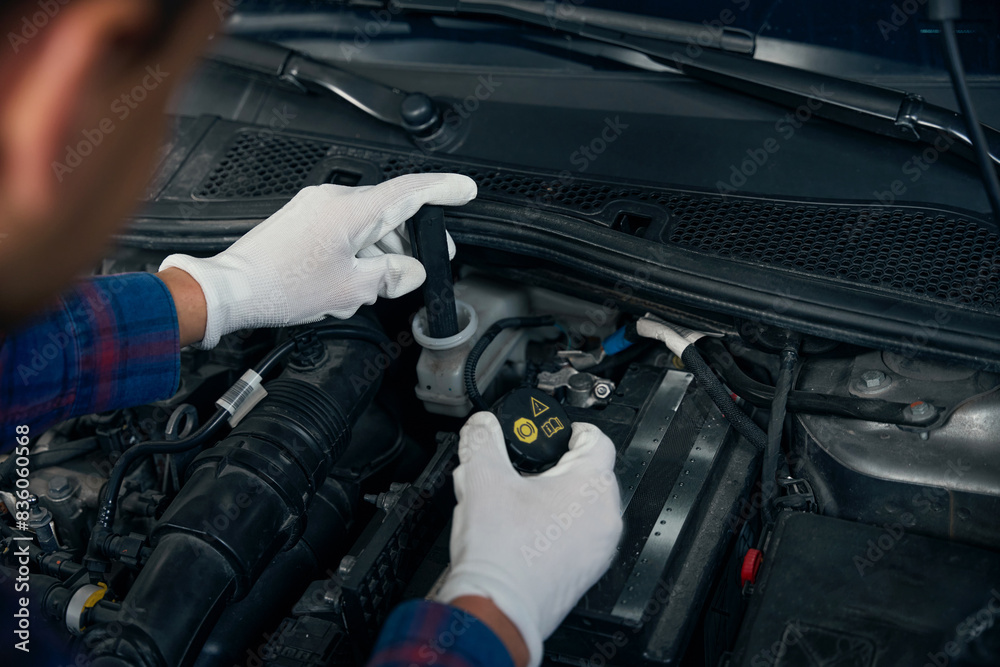 Close up photo of man using car tester Close up photo of man using car tester