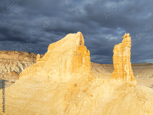 Cumulonimbus clouds over the limestone peaks of Bozjyra (or Boszhira). Ustyurt Plateau, Mangystau region, Kazakhstan.
