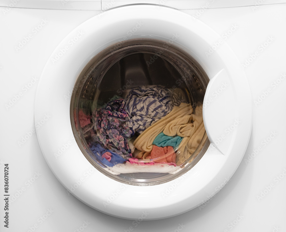 closeup of laundry spinning in washing machine closeup of laundry spinning in washing machine