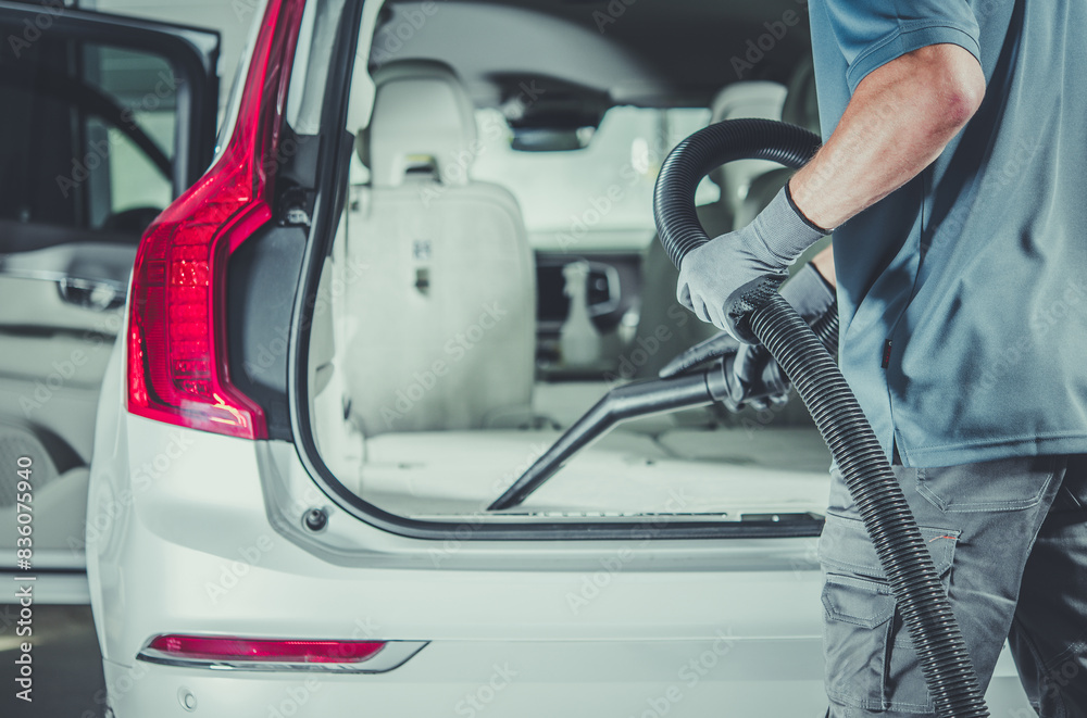 Person Vacuuming Car Trunk Person Vacuuming Car Trunk