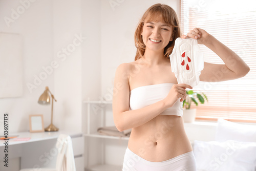 Young woman holding menstru...