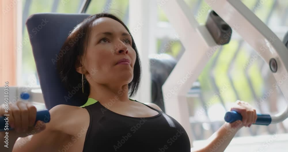 Caucasian woman in excellent physical shape during gym workout. Bench press for chest. Physical education as a norm of life to maintain health. Slow motion 4k footage. Caucasian woman in excellent physical shape during gym workout. Bench press for chest. Physical education as a norm of life to maintain health. Slow motion 4k footage.