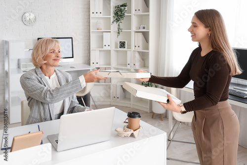 Mature businesswoman taking...