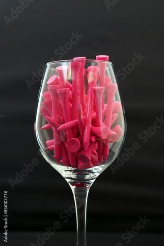 Pink Golf Tees in a Wine Glass