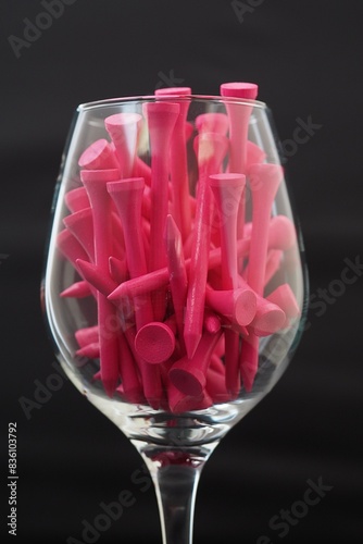Pink Golf Tees in a Wine Glass