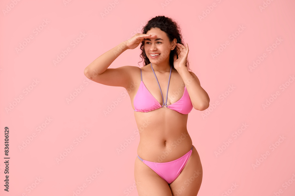 Beautiful young African-American woman in stylish swimsuit on pink background Beautiful young African-American woman in stylish swimsuit on pink background