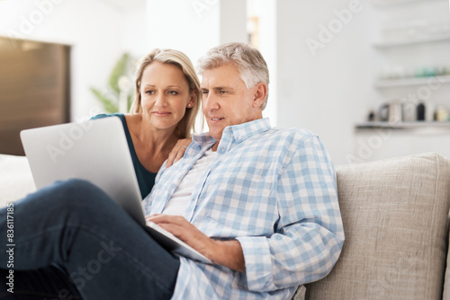 Couple, couch and laptop in home and read, news and email in living room for social media. Internet, computer and relax for website or streaming with married people, calm and lounge with technology