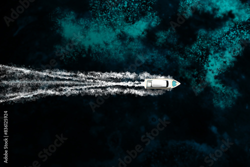 An expensive yacht sails on the ocean, top view