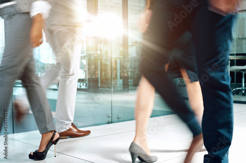 Office, motion blur and legs of people for walking, movement and corporate staff in workplace. Business employees, ground and floor by lobby, corridor and hallway with shoes or feet in action