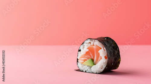 Sushi roll with salmon avocado and rice on isolate pink color background photo