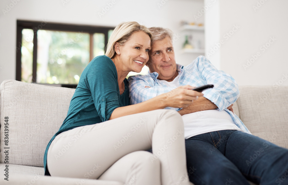 Home, couple and relax with tv remote on sofa for online film, streaming service and search. Mature man, woman and smile with television in living room for movie, entertainment and broadcast of media