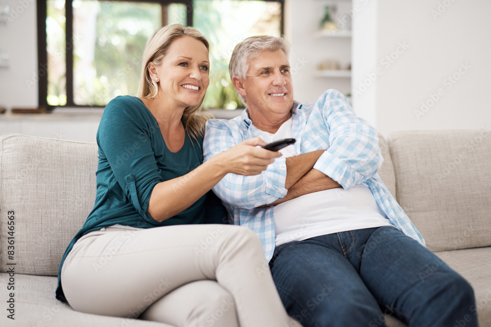 Relax, couple and smile with tv remote on sofa for comedy, online movie and streaming service. Mature man, woman and happy with television at home for film, entertainment and broadcast of media Relax, couple and smile with tv remote on sofa for comedy, online movie and streaming service. Mature man, woman and happy with television at home for film, entertainment and broadcast of media
