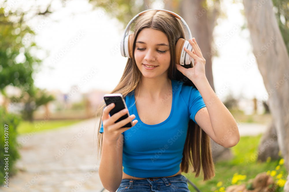 Teenager girl at outdoors using mobile phone Teenager girl at outdoors using mobile phone