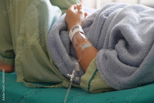 patient receiving intravenous fluid through IV line in the hospital